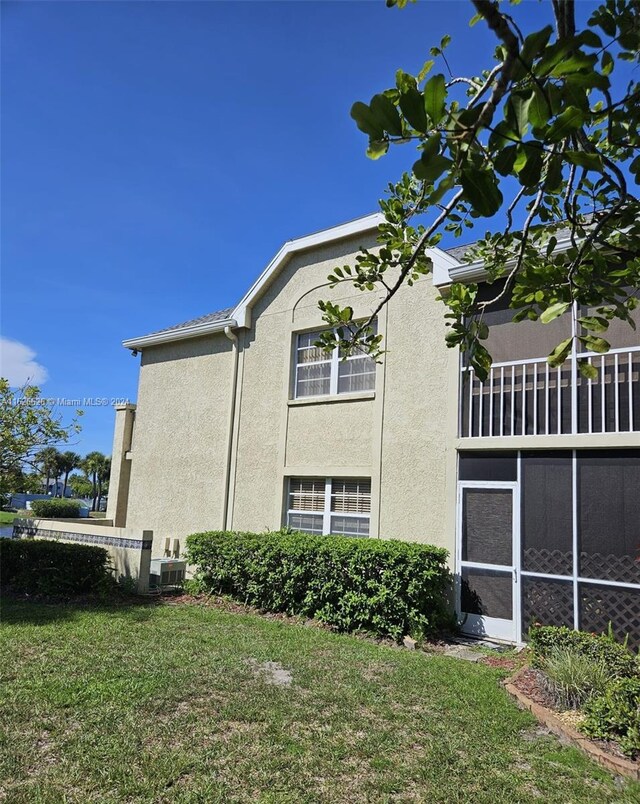 view of side of property with a yard