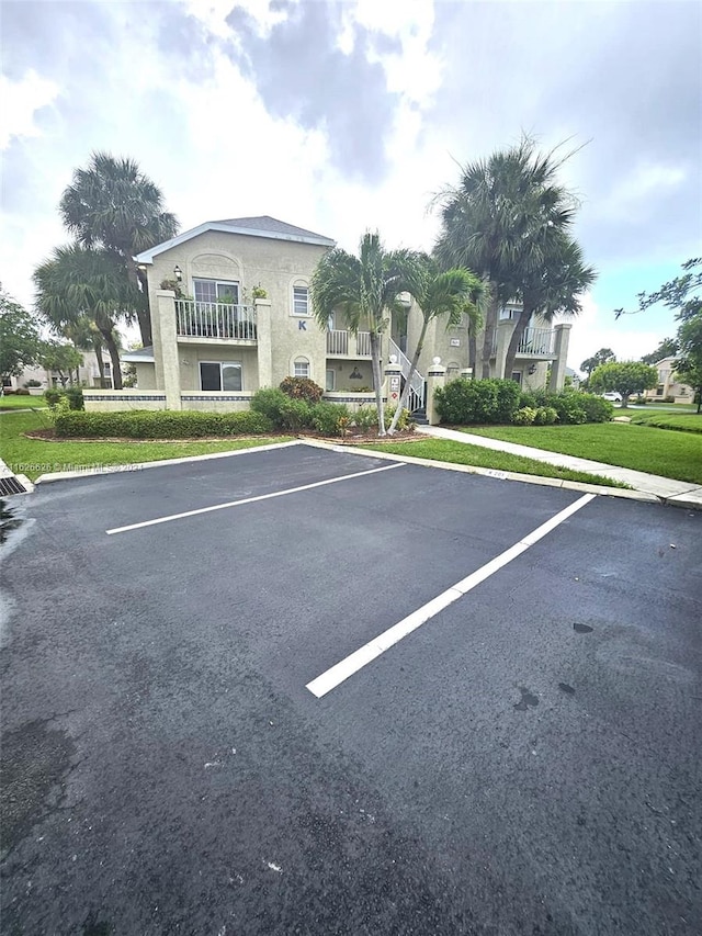 view of car parking featuring a lawn