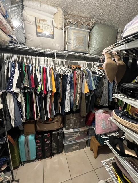 spacious closet featuring tile patterned flooring