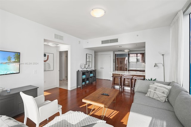 living room featuring dark wood-type flooring