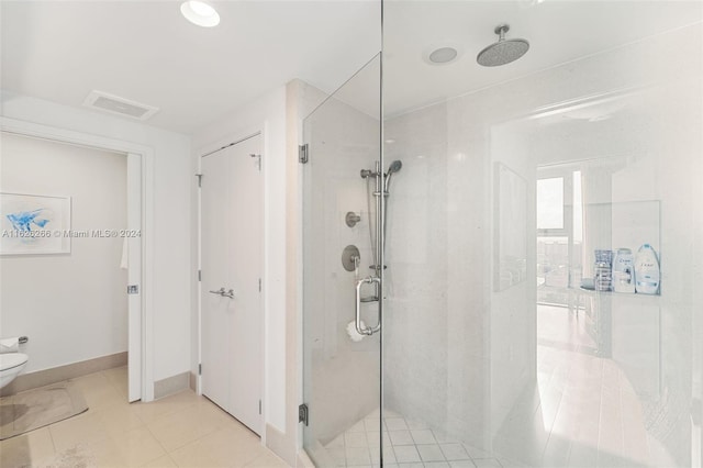 bathroom featuring an enclosed shower and tile patterned flooring