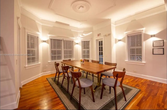 dining area with crown molding and dark hardwood / wood-style flooring