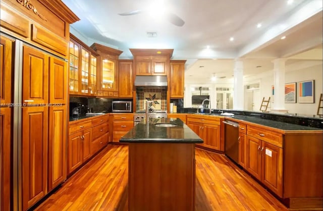 kitchen with sink, backsplash, a center island, kitchen peninsula, and stainless steel appliances