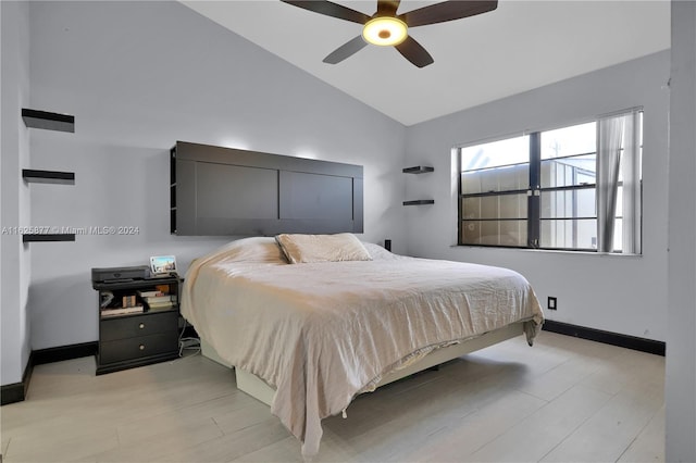 bedroom with light hardwood / wood-style floors, ceiling fan, and high vaulted ceiling