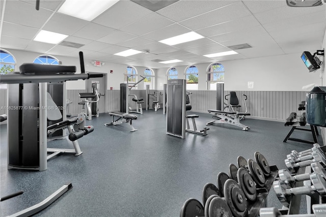 exercise room featuring a drop ceiling and plenty of natural light