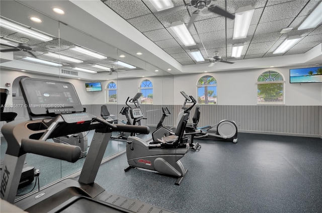 exercise room featuring a drop ceiling and ceiling fan