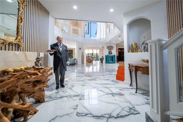 foyer entrance featuring tile patterned floors and a towering ceiling