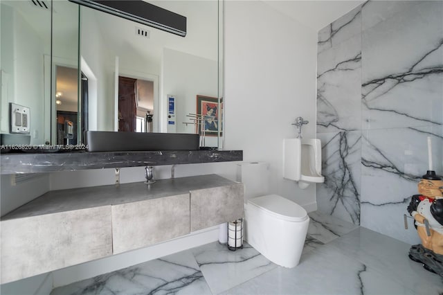 bathroom with double vanity, tile patterned floors, and toilet