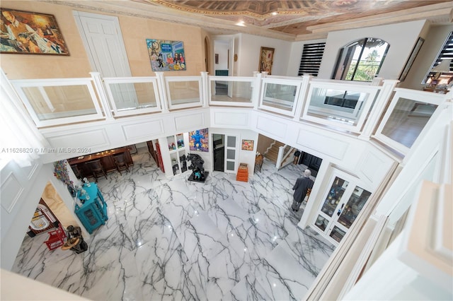 living room with tile patterned flooring and crown molding