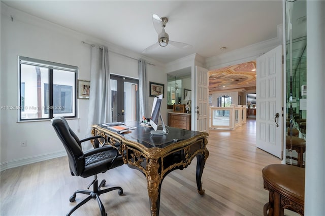 office area with french doors, ornamental molding, light wood-type flooring, and ceiling fan