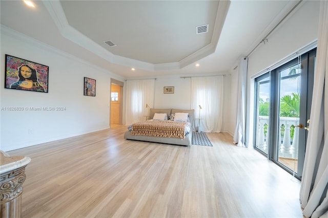 bedroom featuring access to exterior, light wood-type flooring, crown molding, and a raised ceiling