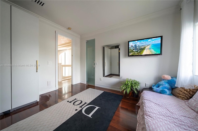 bedroom featuring dark hardwood / wood-style flooring and ornamental molding