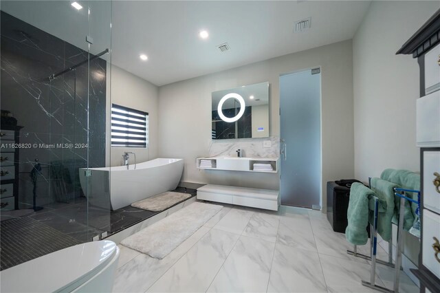 bathroom featuring tile patterned floors and separate shower and tub