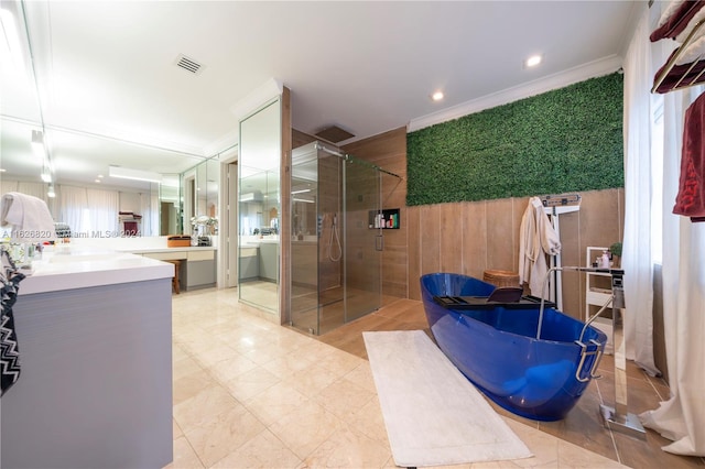 bathroom with shower with separate bathtub, vanity, crown molding, and tile patterned flooring