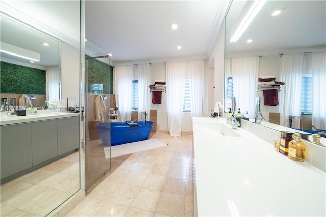 bathroom with a shower with door, vanity, crown molding, and tile patterned floors