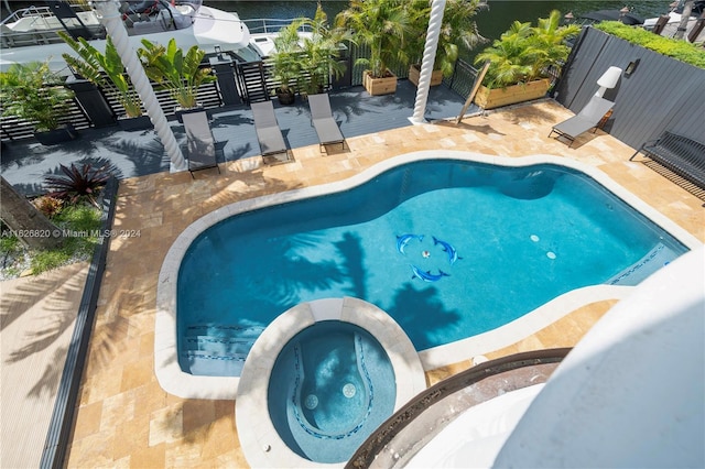 view of pool with an in ground hot tub and a patio