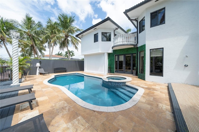 view of pool with an in ground hot tub and a patio area