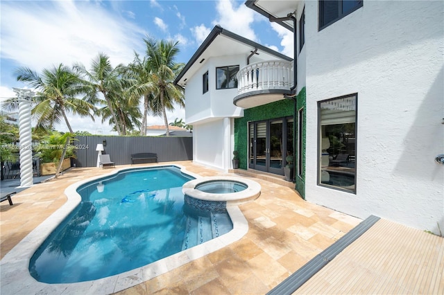 view of swimming pool featuring an in ground hot tub and a patio area