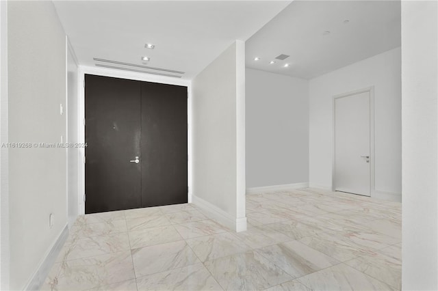 interior space with marble finish floor, visible vents, and baseboards