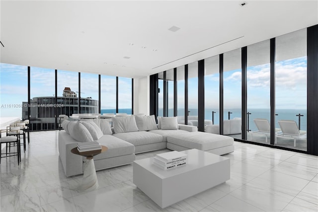 living room with a wall of windows, marble finish floor, and a water view