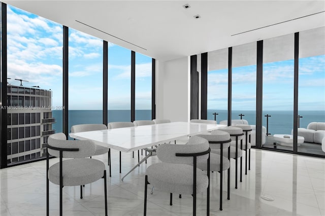 dining space with a wall of windows and a water view