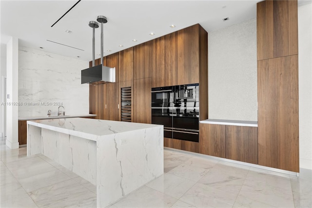 kitchen with a center island, marble finish floor, brown cabinets, modern cabinets, and pendant lighting