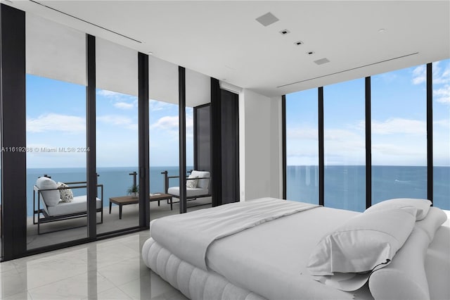 bedroom with a water view and expansive windows