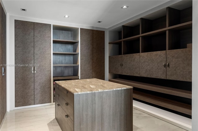 spacious closet with marble finish floor