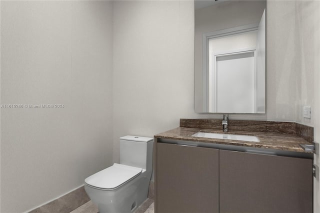 bathroom with toilet and vanity