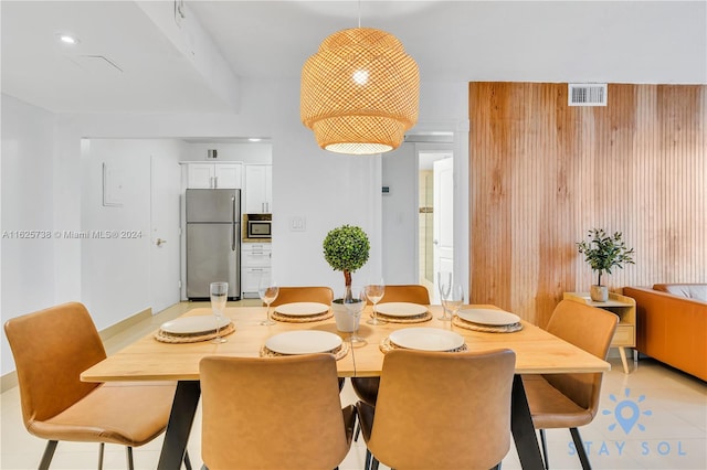 tiled dining area with wood walls