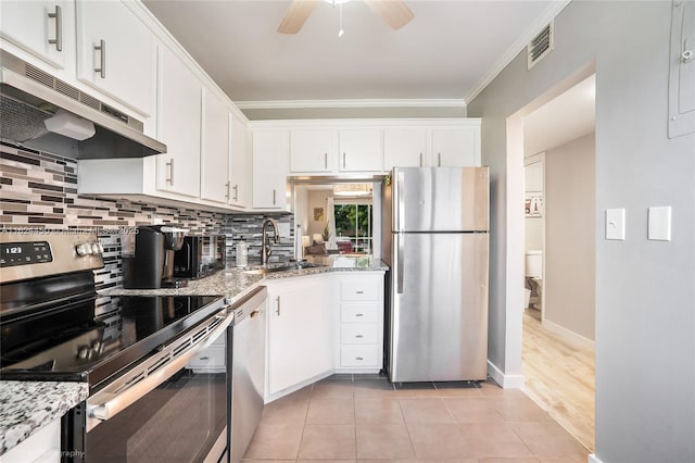 kitchen featuring light stone counters, stainless steel appliances, sink, and white cabinets