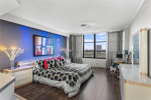 bedroom with ceiling fan, a textured ceiling, dark hardwood / wood-style floors, and ornamental molding