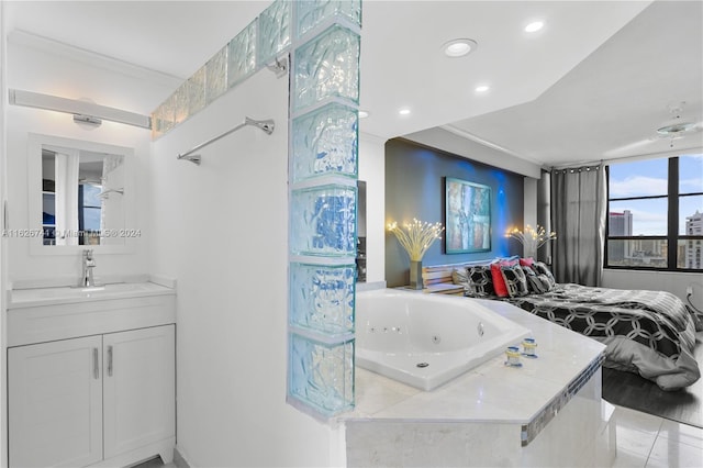 bathroom with tiled bath, vanity, and crown molding