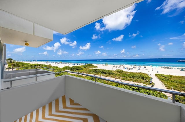 balcony with a water view and a beach view