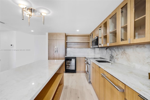 kitchen featuring modern cabinets, beverage cooler, open shelves, a sink, and light wood-style floors