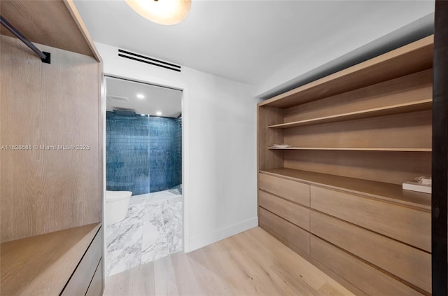 walk in closet featuring visible vents and light wood-type flooring