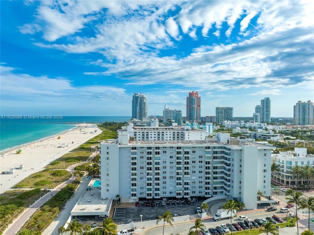 drone / aerial view with a view of city, a view of the beach, and a water view