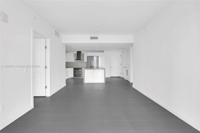 unfurnished living room with dark tile patterned floors