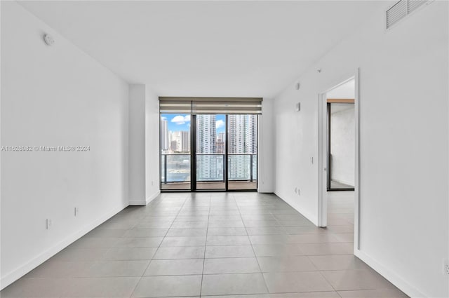 unfurnished room with light tile patterned floors