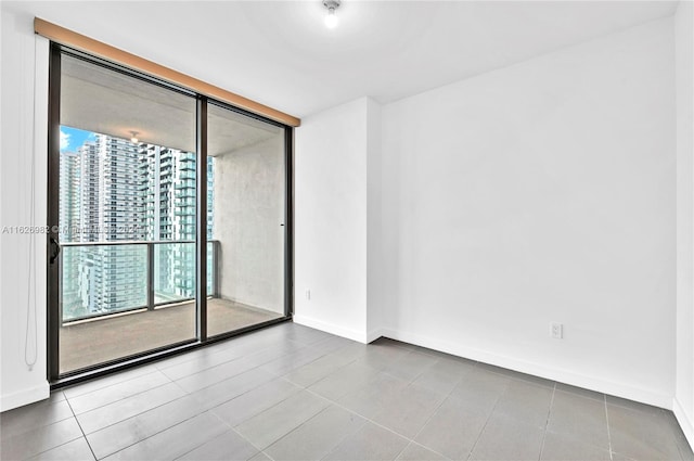 tiled spare room with expansive windows