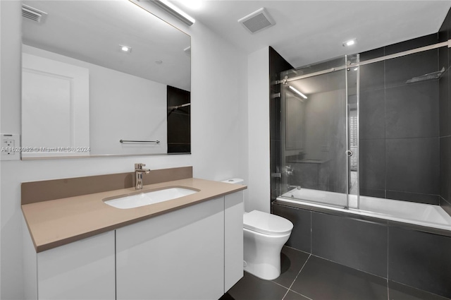 full bathroom with vanity, toilet, tile patterned floors, and enclosed tub / shower combo