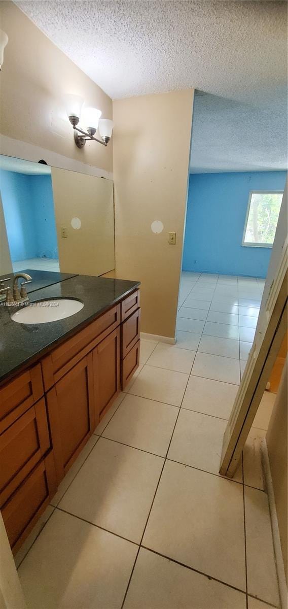 bathroom featuring vanity, a textured ceiling, and tile patterned floors