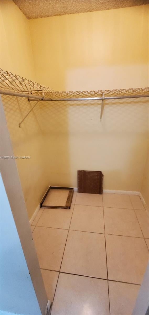 spacious closet with tile patterned floors