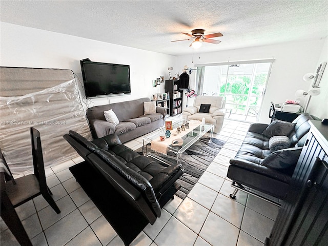 tiled living room with a textured ceiling and ceiling fan