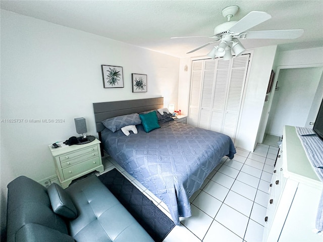 tiled bedroom with a closet and ceiling fan