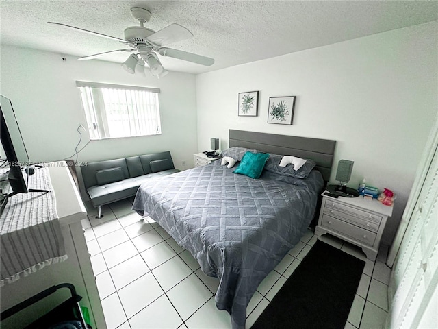 bedroom with light tile patterned floors, a textured ceiling, and ceiling fan