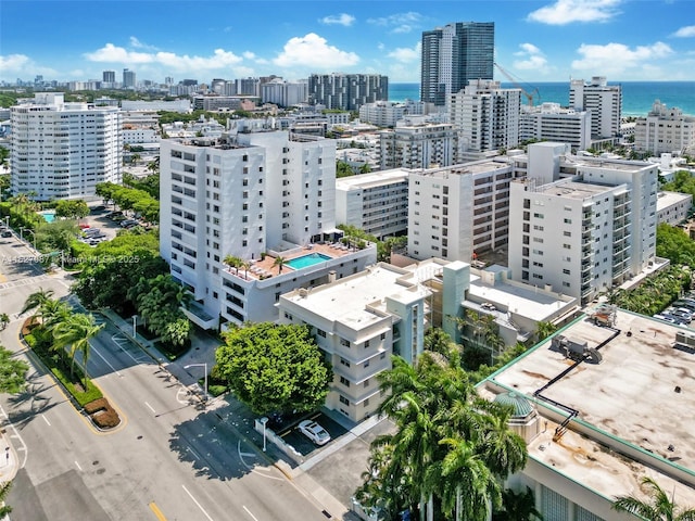 drone / aerial view featuring a city view and a water view