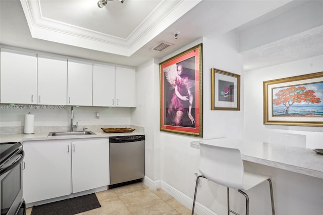 kitchen featuring electric range oven, a tray ceiling, light countertops, stainless steel dishwasher, and a sink