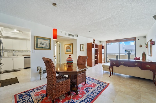 dining space featuring visible vents, a textured ceiling, and light tile patterned floors