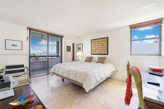 bedroom featuring light tile patterned floors, baseboards, multiple windows, and access to exterior